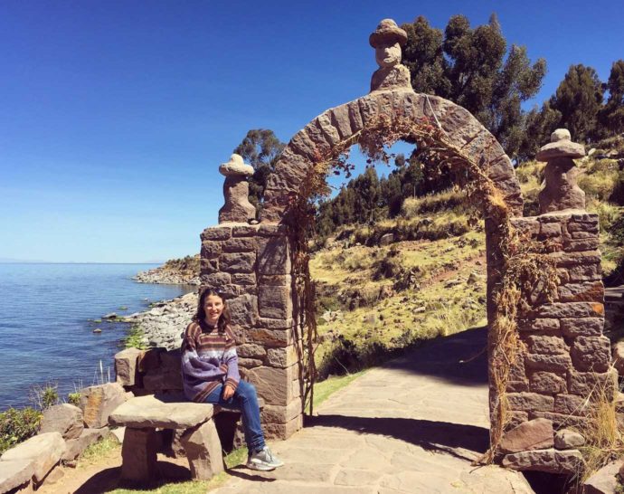 overview of lake Titicaca. me sat by an arch on taquile island