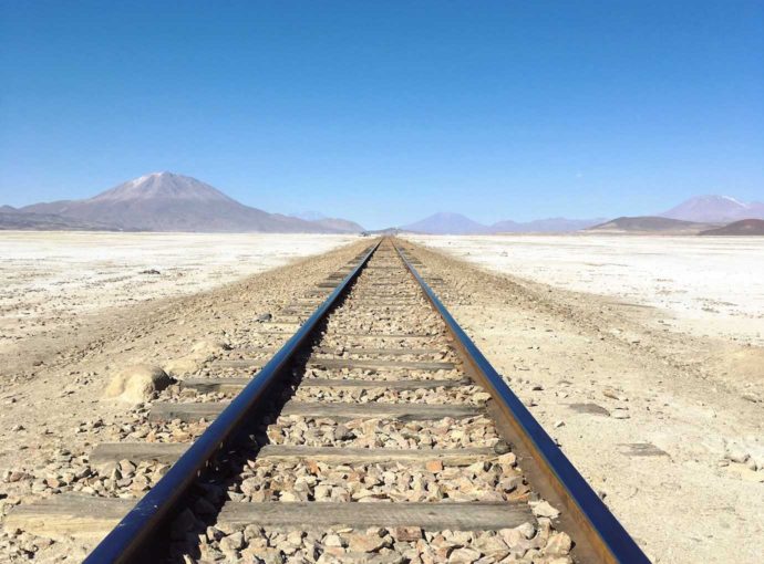 3 day salt flat tour. Railway with volcano in distance day 2