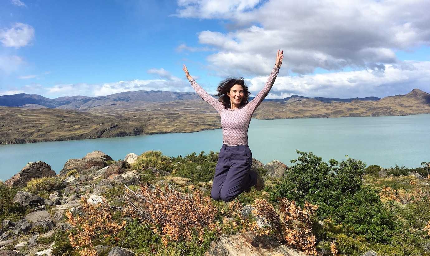 me jumping for joy with blue lake Torres del Paine W trek